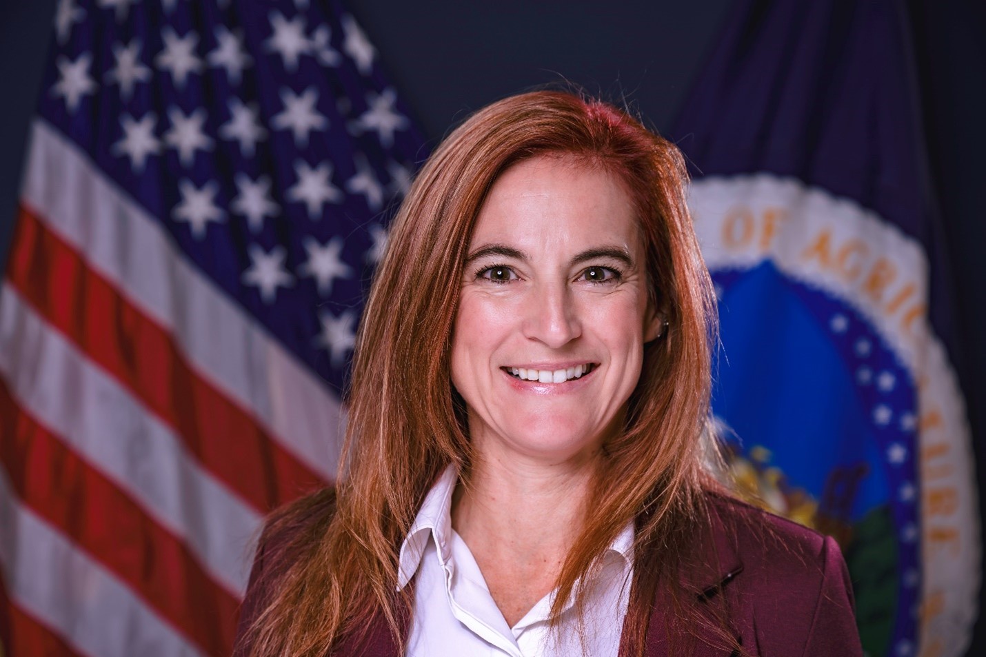 Smiling woman posing with American flag background