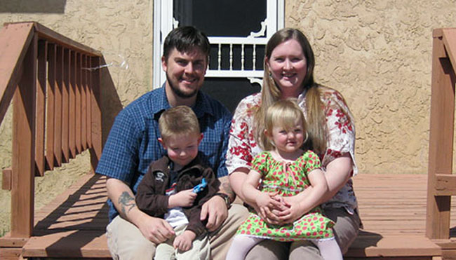 Family smiling on wooden deck in sunlight Family smiling on wooden deck in sunlight